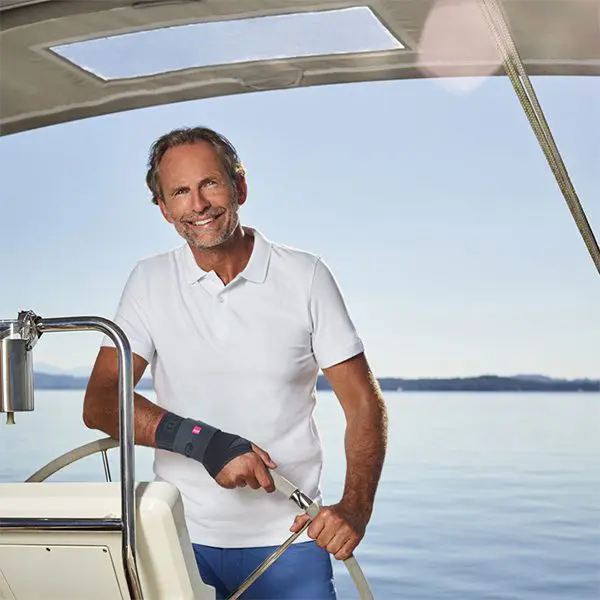 Happy man sailing under blue sky