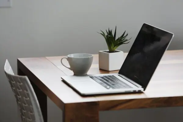 Modern workspace with laptop and coffee cup.